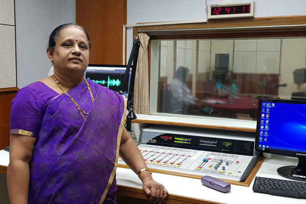 Asian lady wearing purple in radio station